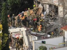 Israeli rescuers search for missing in building strike by Iranian missile, two dead Israeli rescuers search for missing in building strike by Iranian missile, two dead