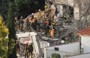 Israeli rescuers search for missing in building strike by Iranian missile, two dead Israeli rescuers search for missing in building strike by Iranian missile, two dead