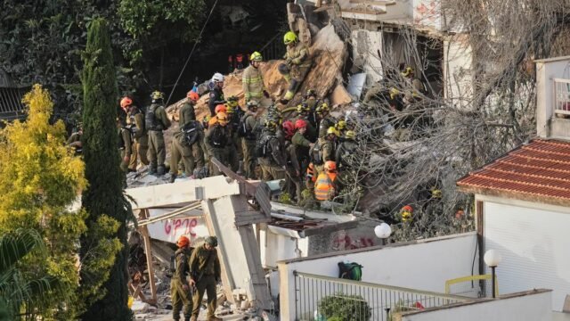 Israeli rescuers search for missing in building strike by Iranian Israeli rescuers search for missing in building strike by Iranian missile, two dead