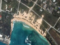 Searchers find body of 1 of 6 missing crew members from ship that overturned during typhoon Searchers find body of 1 of 6 missing crew members from ship that overturned during typhoon