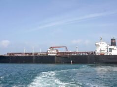 ‘Ties Between India, Iran Very Strong’: Tehran’s Envoy After Tanker Attacked Near Hormuz A woman talks on a phone while standing amid a damaged residential neighbourhood hit by a strike amid the US-Israeli conflict. (IMAGE: REUTERS)